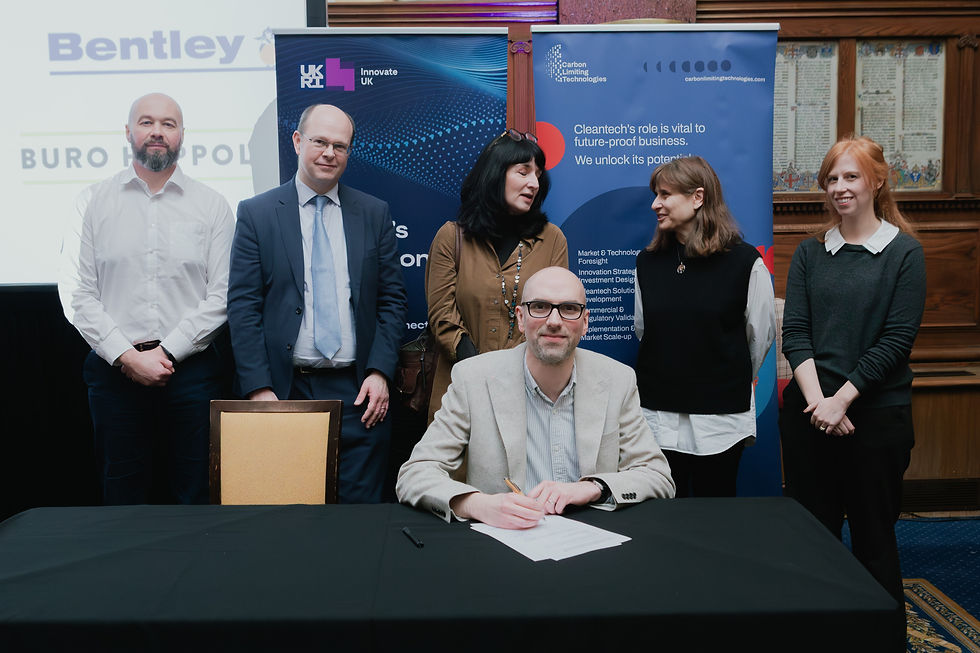 Chris Bolton of JN Bentley signing commitment with other signatories stood behind