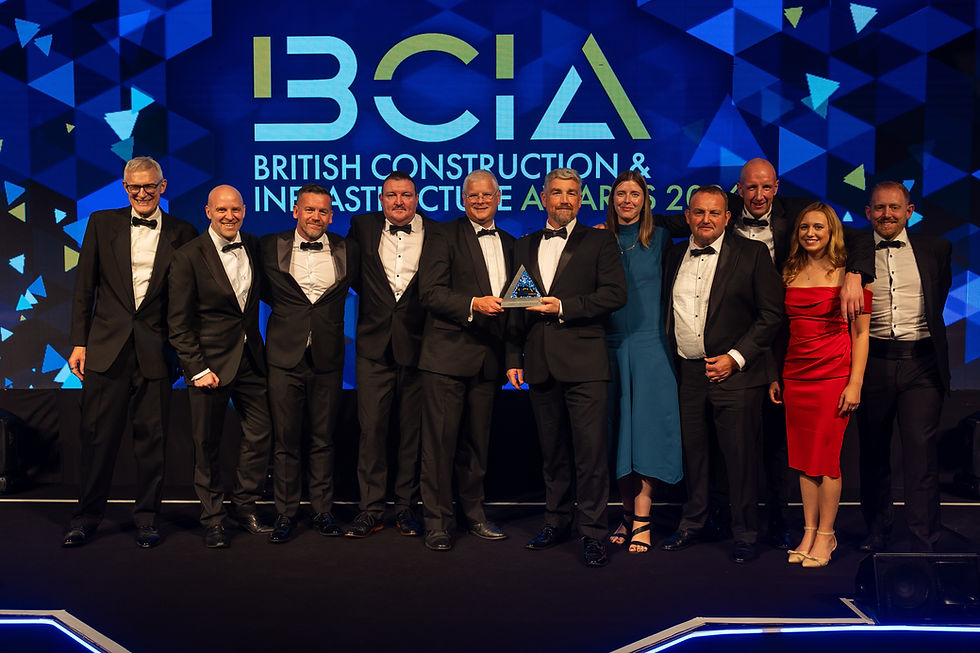 A group of people accepting an award on stage.