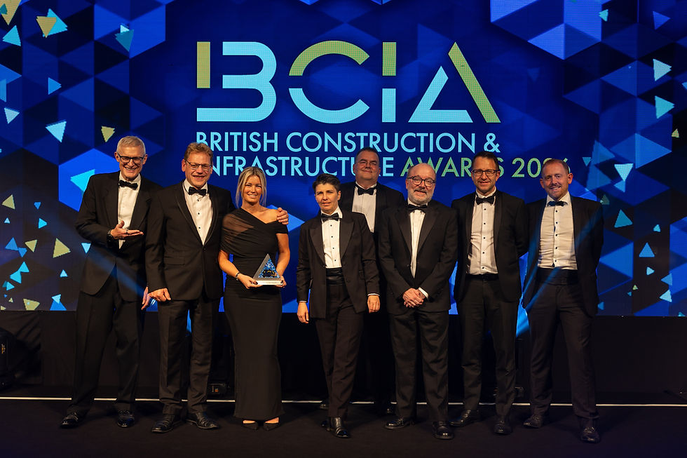 A group of people accepting an award on stage.