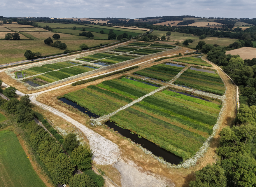 Aerial view of wetlands surrounded by countryside.