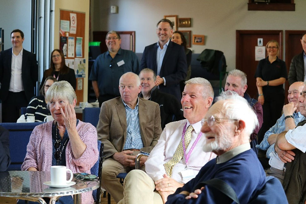 People sat in a room smiling